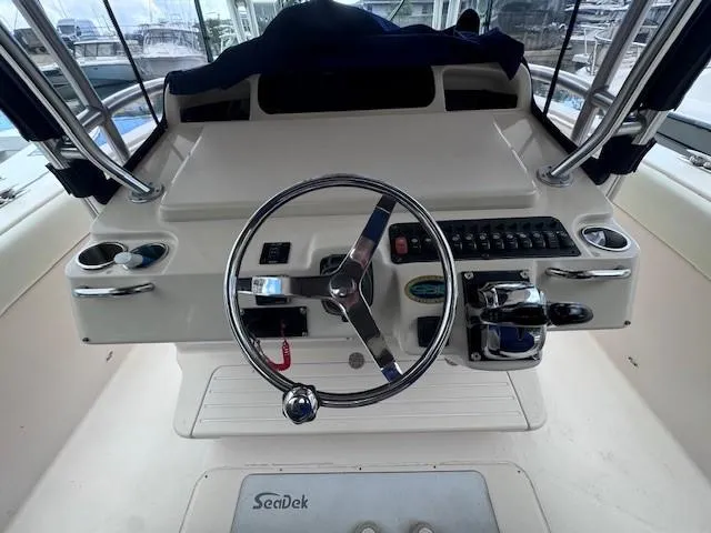 Slide: The Image of Helm of 2008 Grady-White 336 Canyon boat with steering wheel and controls. - 33