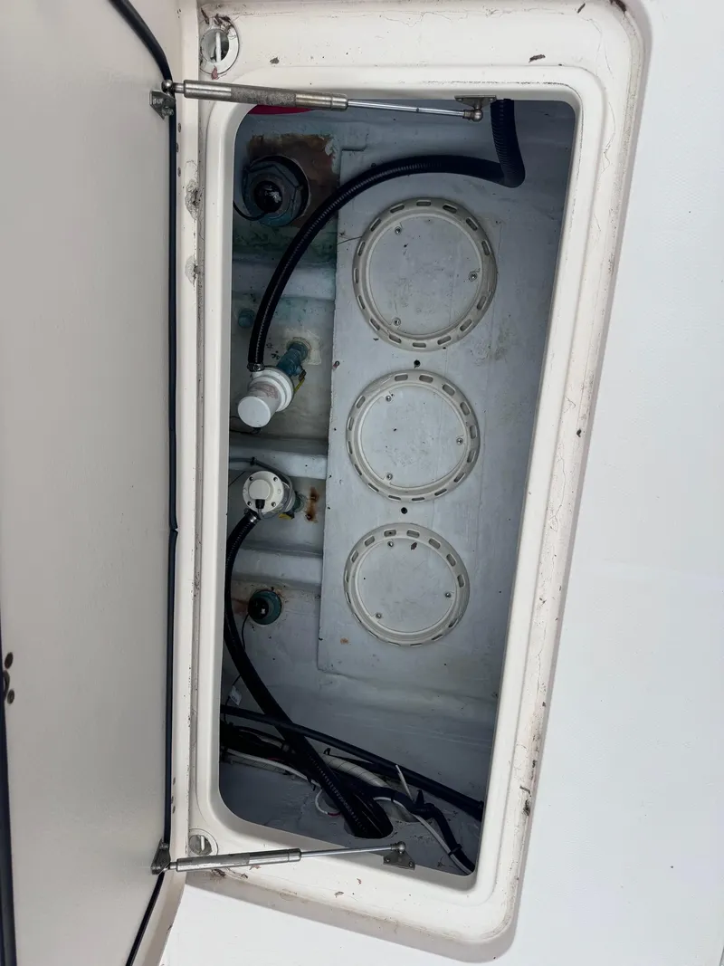 Slide: The Image of Open storage compartment on a 2008 Grady-White 336 Canyon boat, showing internal components. - 39