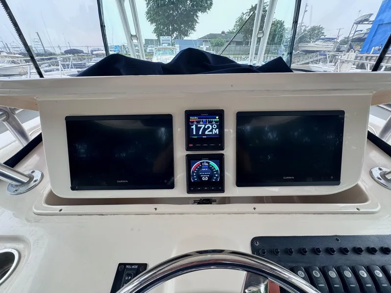 Slide: The Image of Helm of 2008 Grady-White 336 Canyon with Garmin displays and steering wheel. - 45