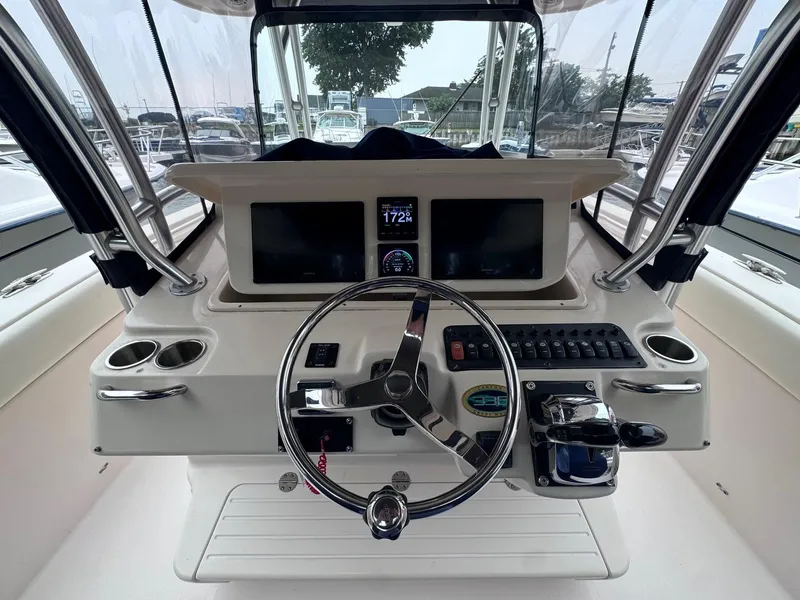 Slide: The Image of 2008 Grady-White 336 Canyon boat helm with steering wheel and control panel. - 46