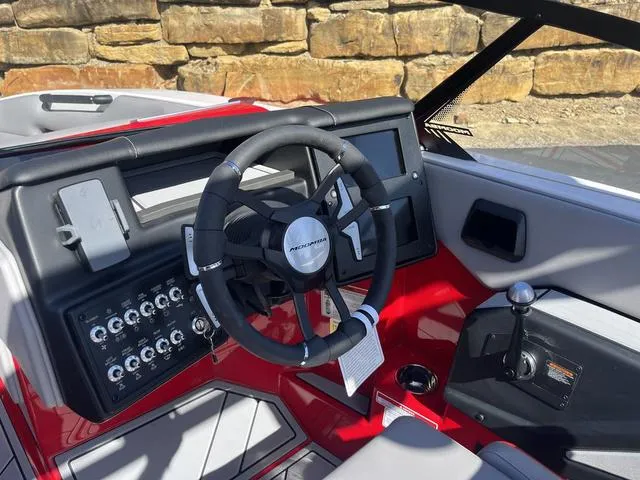 Slide: The Image of 2024 Moomba Mojo boat dashboard with steering wheel and control panel. - 12
