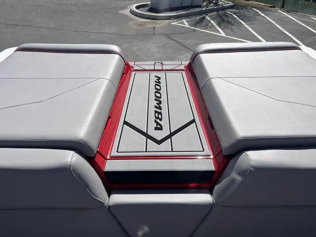 Slide: The Image of 2024 Moomba Mojo boat with sleek gray seating and red accents. - 14