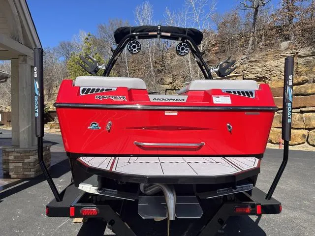 Slide: The Image of 2024 Moomba Mojo boat in vibrant red, rear view with speakers and seating. - 16