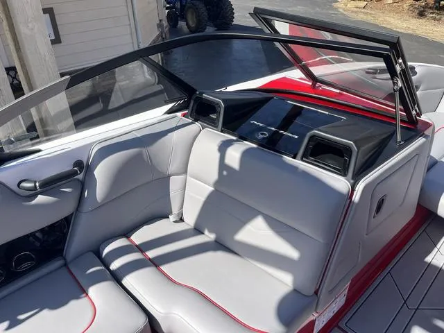 Slide: The Image of 2024 Moomba Mojo boat interior with gray seating and red accents. - 4