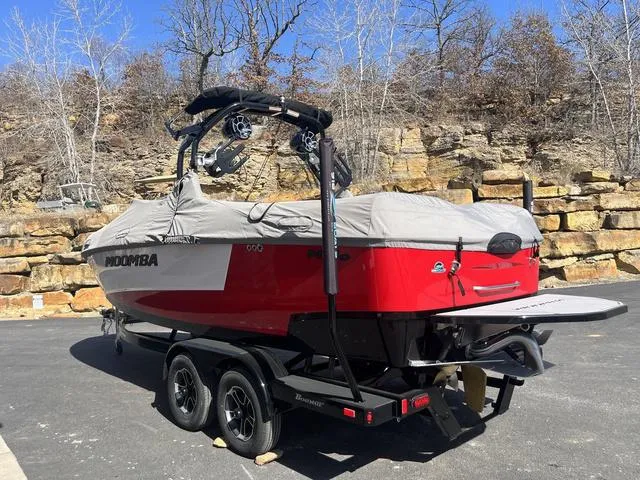 Slide: The Image of 2024 Moomba Mojo boat on trailer, covered, parked outdoors near rocky terrain. - 5