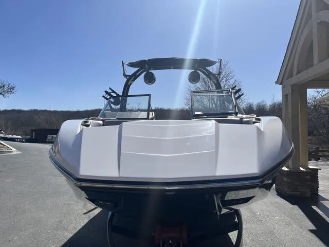 Slide: The Image of 2024 Moomba Mojo boat parked outdoors under clear blue sky. - 9