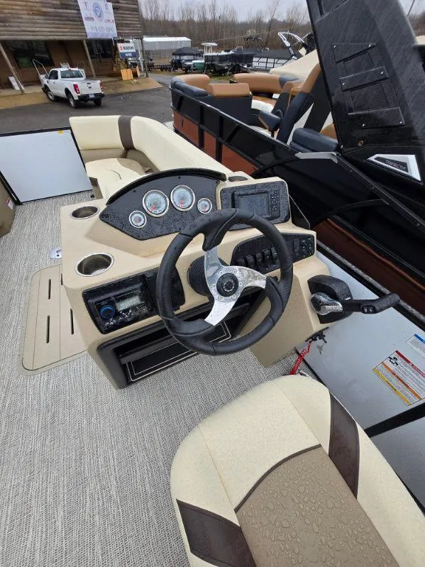 Slide: The Image of 2025 G3 SELECT 322SS boat interior with steering wheel and control panel. - 5