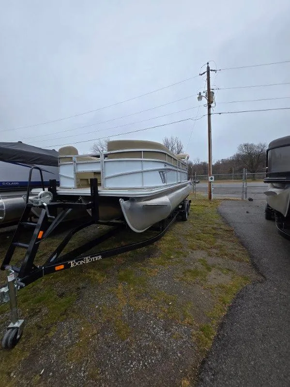 Slide: The Image of 2025 G3 SELECT 322SS pontoon boat on trailer, parked outdoors. - 6