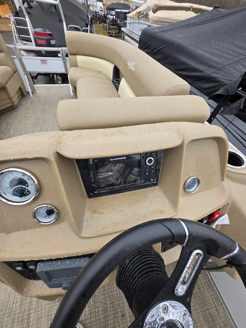 Slide: The Image of 2025 G3 SELECT 322SS boat interior with steering wheel and control panel. - 7