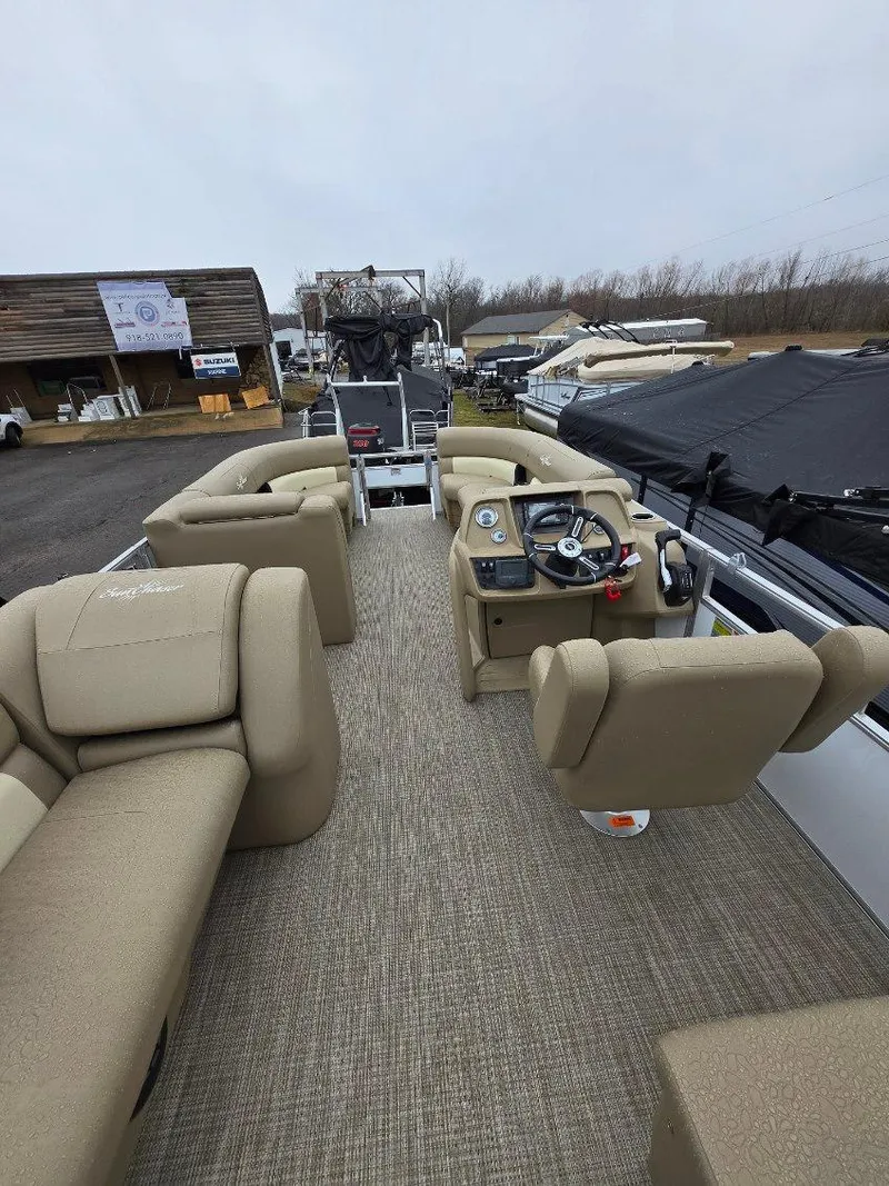 Slide: The Image of 2025 G3 SELECT 322SS boat interior with beige seating and steering console. - 9