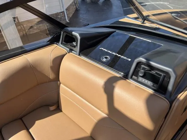 Slide: The Image of 2024 Moomba Mojo boat interior with tan seating and dashboard details. - 11