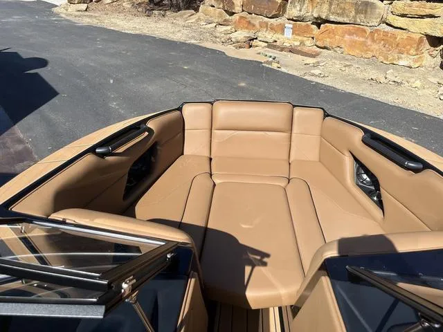 Slide: The Image of 2024 Moomba Mojo boat interior with tan leather seating and sleek design. - 12