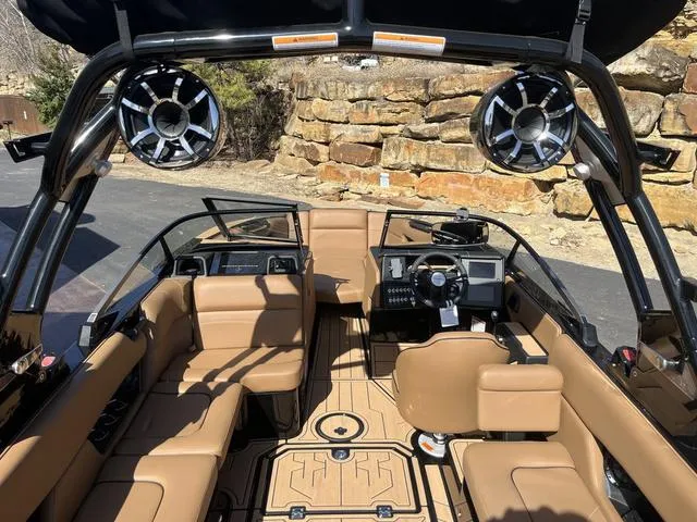 Slide: The Image of 2024 Moomba Mojo boat interior with tan seating and advanced audio system. - 6