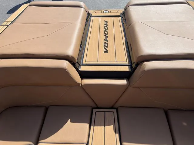 Slide: The Image of 2024 Moomba Mojo boat interior with tan leather seating and branded deck. - 8