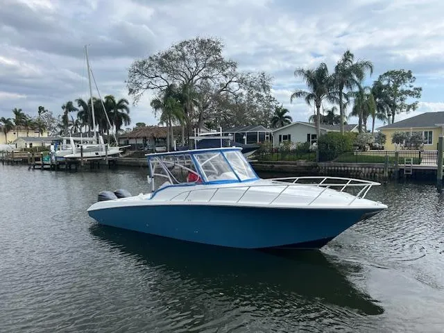 Slide: The Image of 2008 Fountain 33 SFC Sportfish Cruiser in a scenic marina setting. - 0