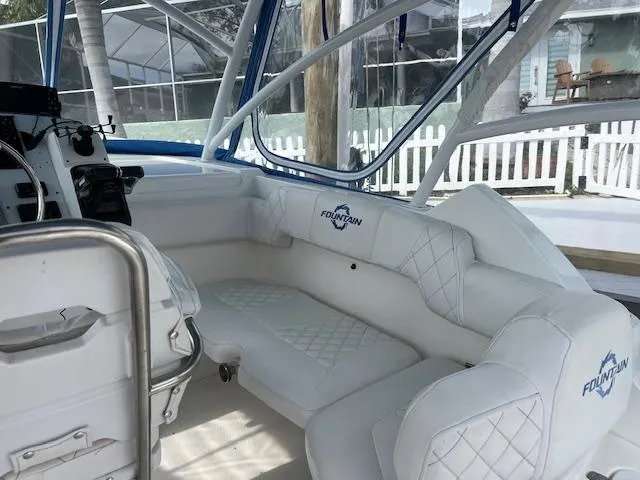 Slide: The Image of 2008 Fountain 33 SFC Sportfish Cruiser interior with white seating and blue accents. - 10