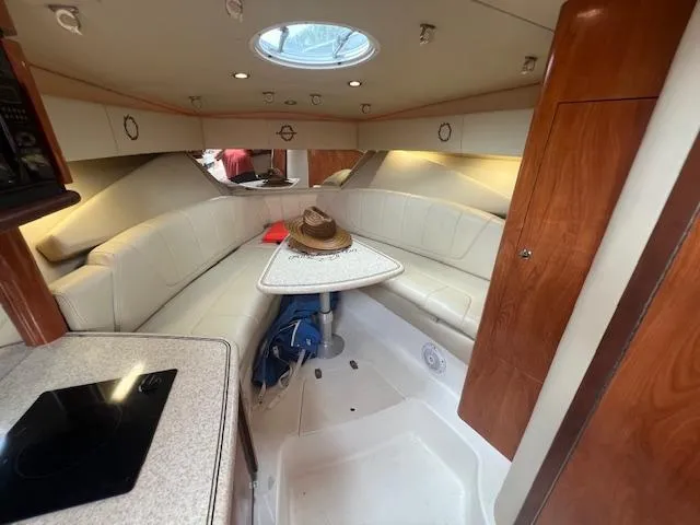 Slide: The Image of 2008 Fountain 33 SFC Sportfish Cruiser interior with seating, table, and modern amenities. - 13