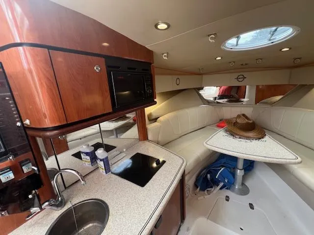 Slide: The Image of 2008 Fountain 33 SFC Sportfish Cruiser interior with kitchenette and seating area. - 14