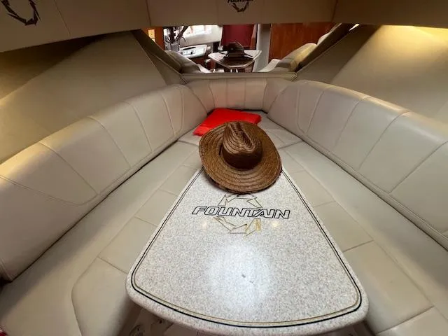Slide: The Image of 2008 Fountain 33 SFC Sportfish Cruiser cabin with hat on table. - 15