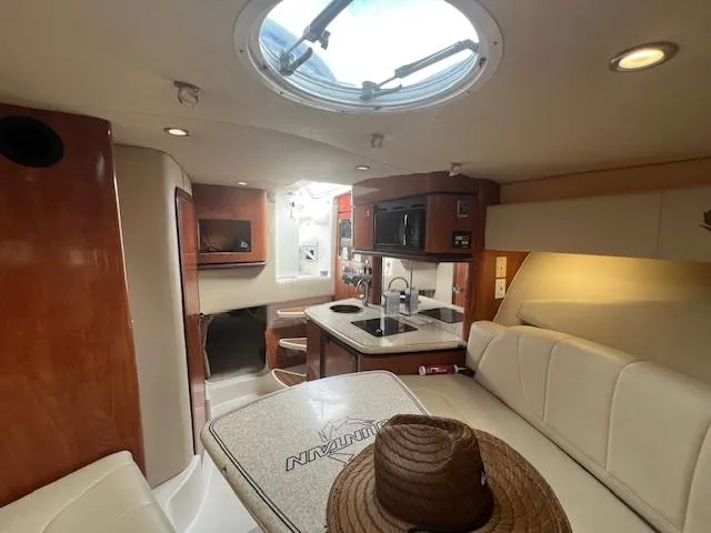 Slide: The Image of 2008 Fountain 33 SFC Sportfish Cruiser interior with kitchen, seating, and skylight. - 16