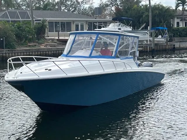 Slide: The Image of 2008 Fountain 33 SFC Sportfish Cruiser on water, featuring sleek blue and white design. - 3