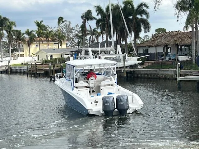 Slide: The Image of 2008 Fountain 33 SFC Sportfish Cruiser on a scenic waterway with palm trees. - 5