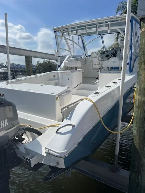 Slide: The Image of 2008 Fountain 33 SFC Sportfish Cruiser, docked, showcasing spacious deck and dual Yamaha engines. - 8