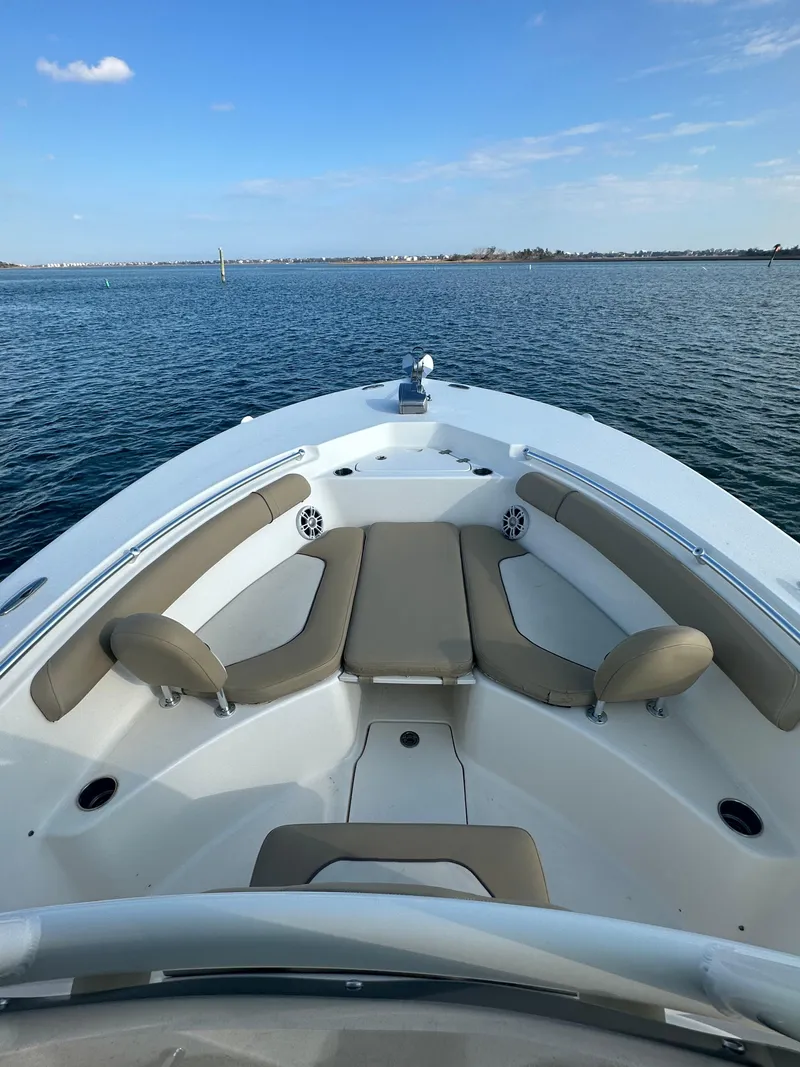 Slide: The Image of 2018 Key West 244 CC boat on calm water, featuring spacious seating and clear blue skies. - 11