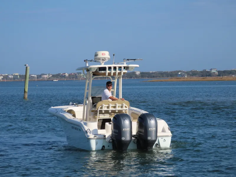Slide: The Image of 2018 Key West 244 CC boat with dual engines on open water. - 3