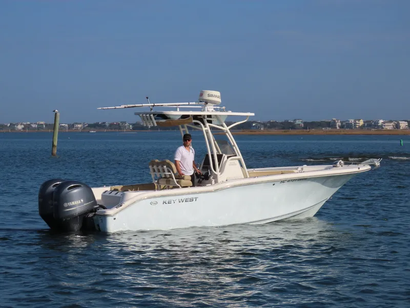 Slide: The Image of 2018 Key West 244 CC boat on calm water with Yamaha engines. - 4