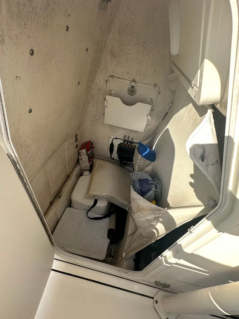 Slide: The Image of Interior storage compartment of 2018 Key West 244 CC boat, showing various items. - 6