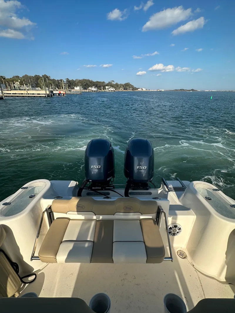 Slide: The Image of 2018 Key West 244 CC boat with dual engines on open water under a clear sky. - 8