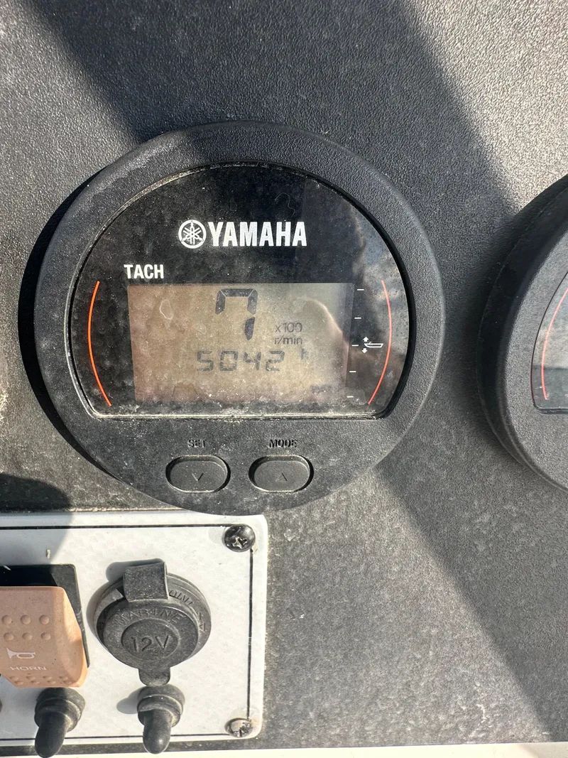 Slide: The Image of Yamaha tachometer on 2018 Key West 244 CC boat dashboard, showing 504.2 hours. - 9