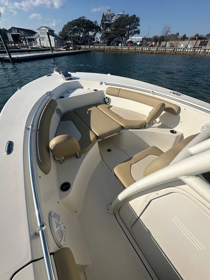 Slide: The Image of 2018 Key West 244 CC boat with beige seating, docked by the waterfront. - 7