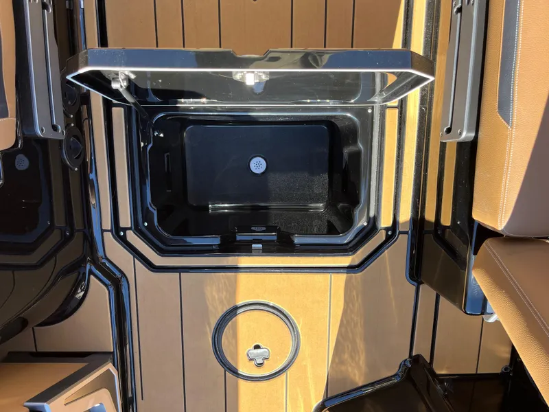 Slide: The Image of 2025 Supra SE boat storage compartment with open lid, showcasing sleek design and functionality. - 13