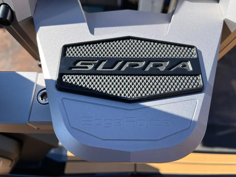 Slide: The Image of 2025 Supra SE badge on metallic surface, featuring textured design. - 15