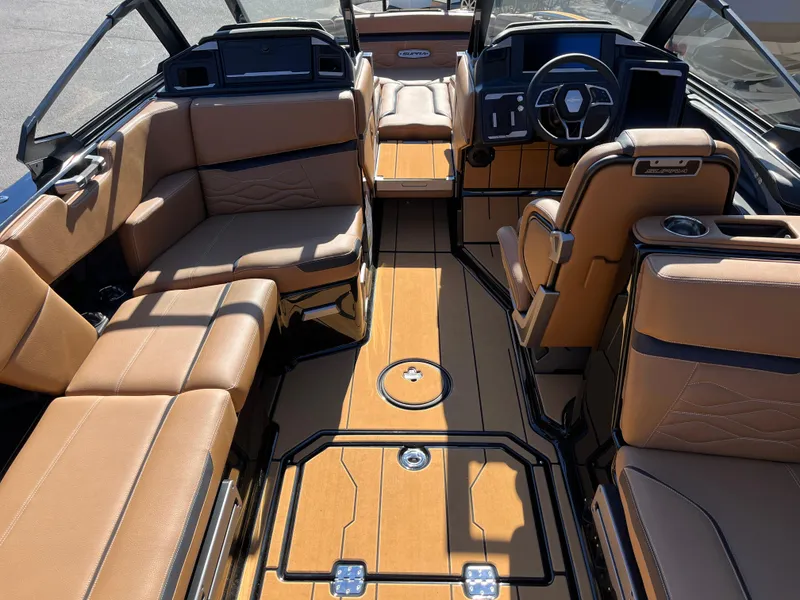 Slide: The Image of 2025 Supra SE boat interior with tan leather seating and modern dashboard design. - 22