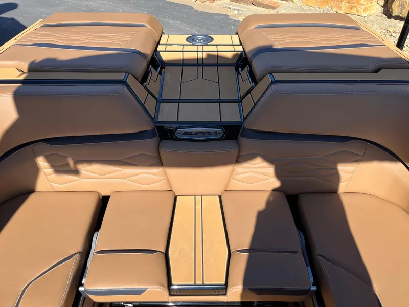 Slide: The Image of 2025 Supra SE boat interior with tan leather seating and sleek design. - 23