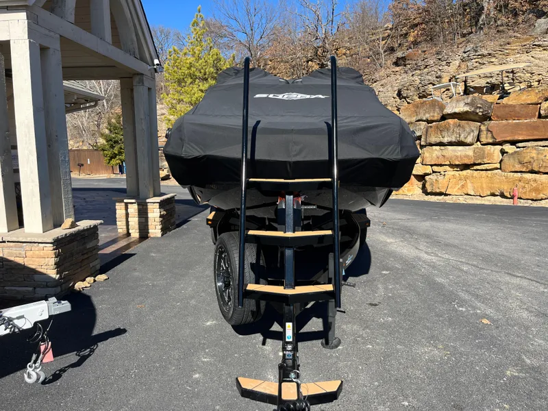 Slide: The Image of 2025 Supra SE boat covered, parked on driveway with ladder access. - 29