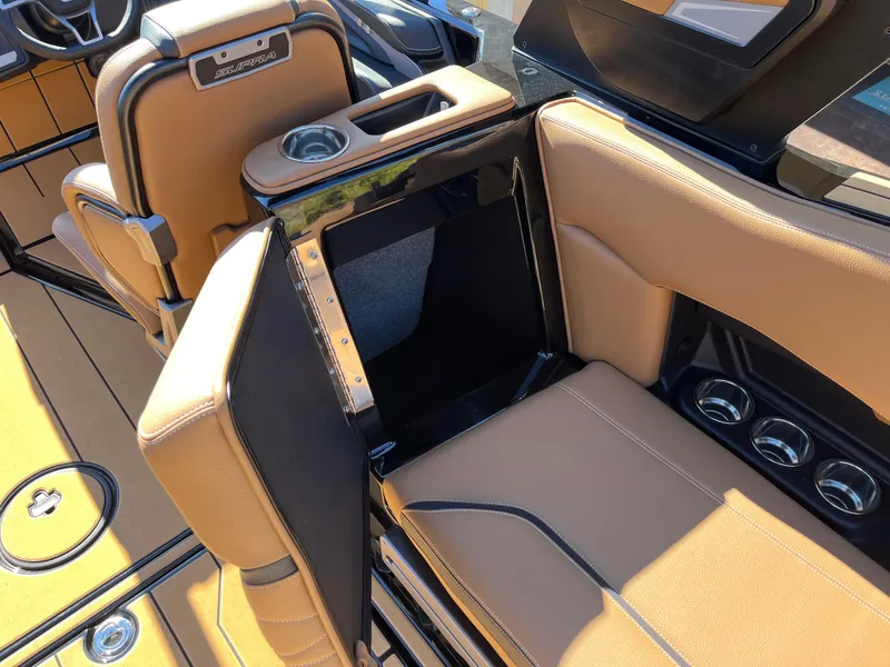 Slide: The Image of 2025 Supra SE interior with tan leather seats and built-in cup holders. - 35