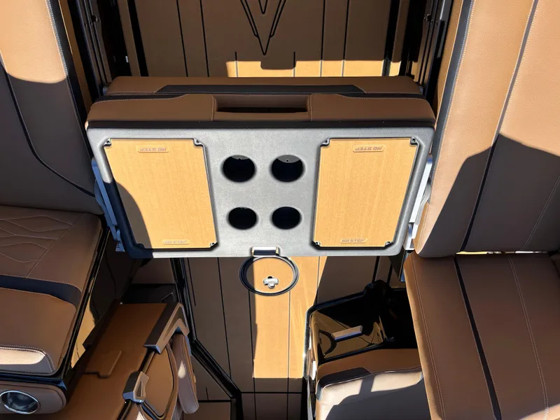 Slide: The Image of 2025 Supra SE interior with tan leather seats and integrated cup holders. - 37