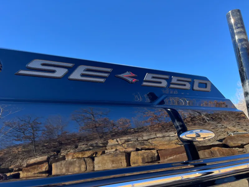 Slide: The Image of 2025 Supra SE 550 badge on a sleek black surface, clear blue sky background. - 4