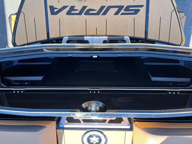 Slide: The Image of 2025 Supra SE boat interior with open storage compartment and sleek design. - 6