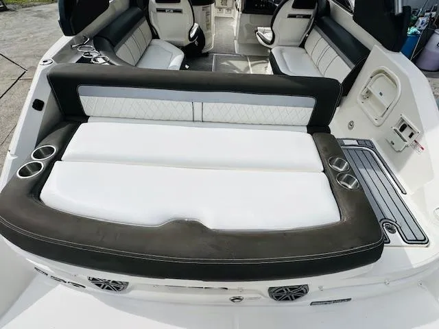 Slide: The Image of 2016 Sea Ray 250 SLX boat interior with white seating and cup holders. - 10