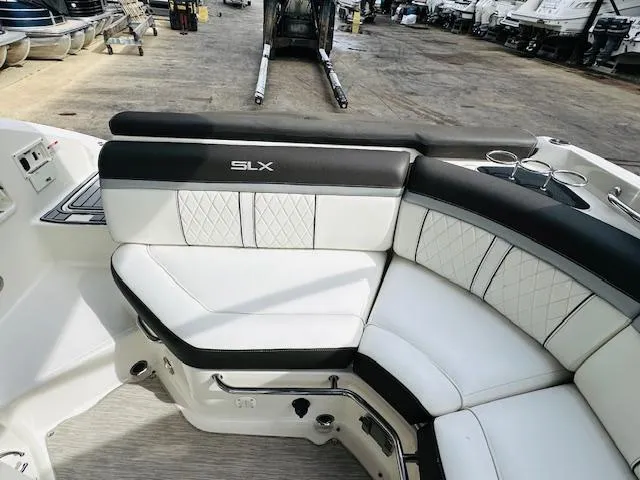 Slide: The Image of 2016 Sea Ray 250 SLX boat interior with white and black seating. - 11