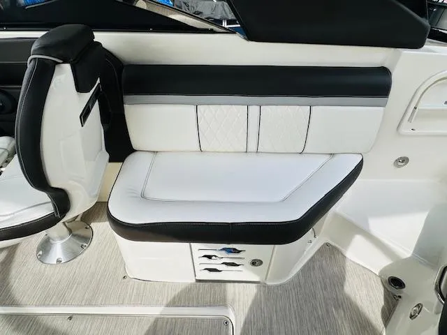 Slide: The Image of 2016 Sea Ray 250 SLX boat interior with white and black seating. - 14