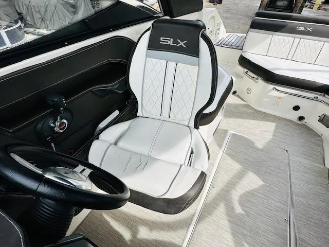 Slide: The Image of Interior of 2016 Sea Ray 250 SLX boat with luxurious seating and steering wheel. - 15