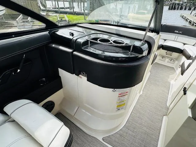 Slide: The Image of 2016 Sea Ray 250 SLX boat interior with seating and cup holders. - 17
