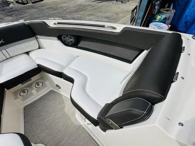 Slide: The Image of 2016 Sea Ray 250 SLX boat interior with black and white seating. - 21