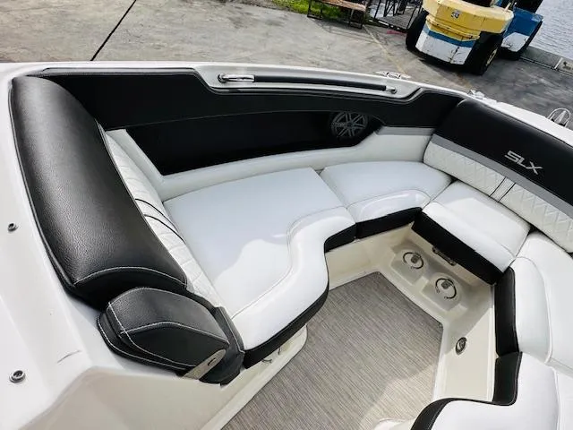 Slide: The Image of Luxurious seating on 2016 Sea Ray 250 SLX boat, featuring sleek black and white upholstery. - 22
